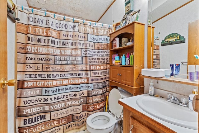 bathroom with a textured ceiling, vanity, toilet, and a shower with curtain