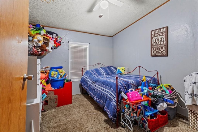 bedroom featuring carpet, a textured ceiling, ornamental molding, and a ceiling fan
