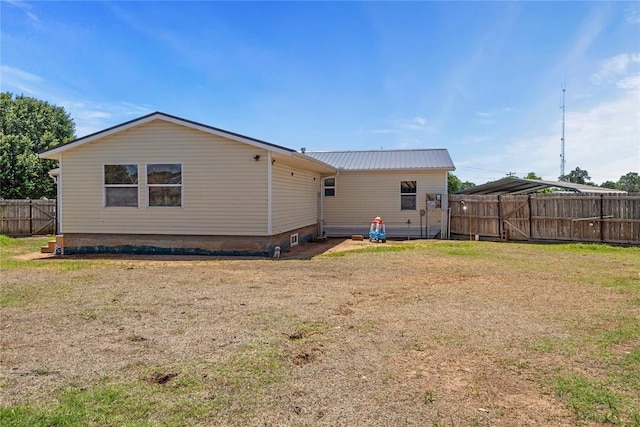 rear view of house featuring metal roof