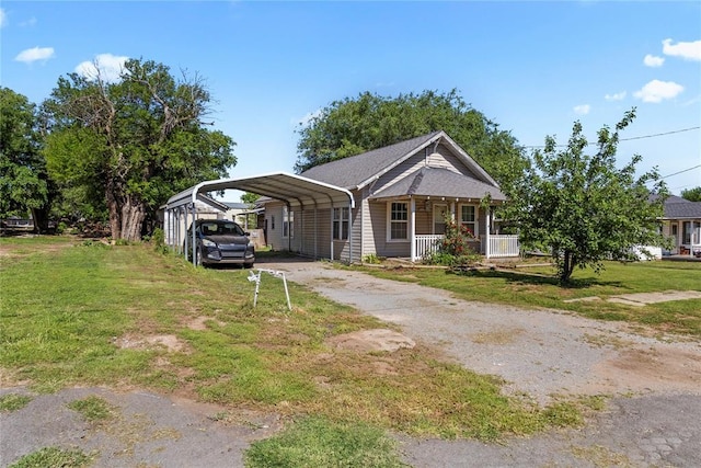 305 N Reimer, Corn, OK 73024 - view of front of property with driveway, a carport, covered porch, and a front yard