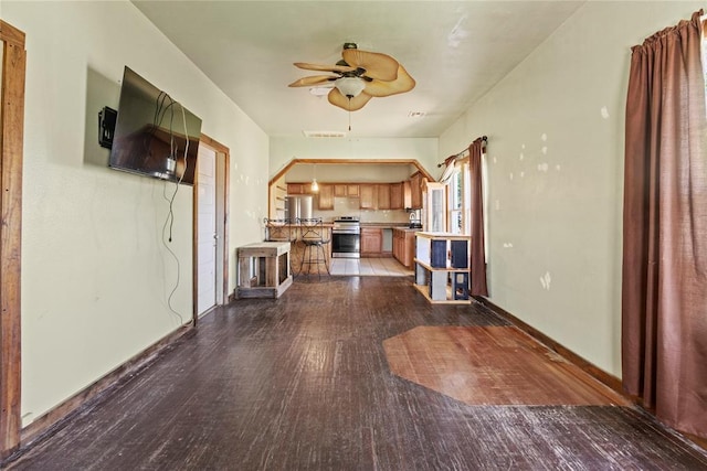 305 N Reimer, Corn, OK 73024 - unfurnished living room with dark wood finished floors, a ceiling fan, and baseboards