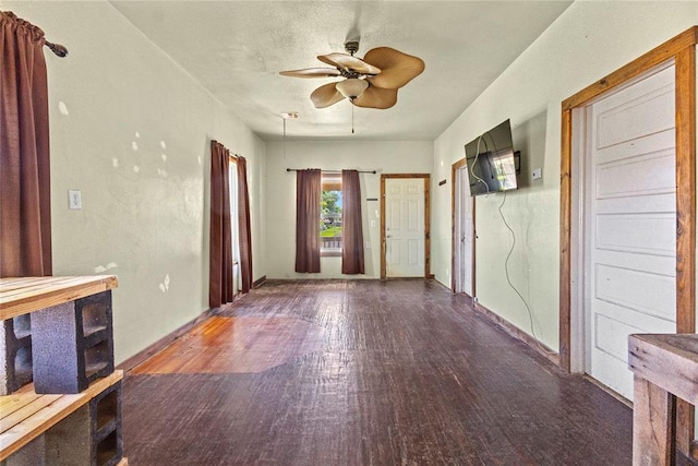305 N Reimer, Corn, OK 73024 - unfurnished living room featuring wood finished floors, a ceiling fan, and baseboards