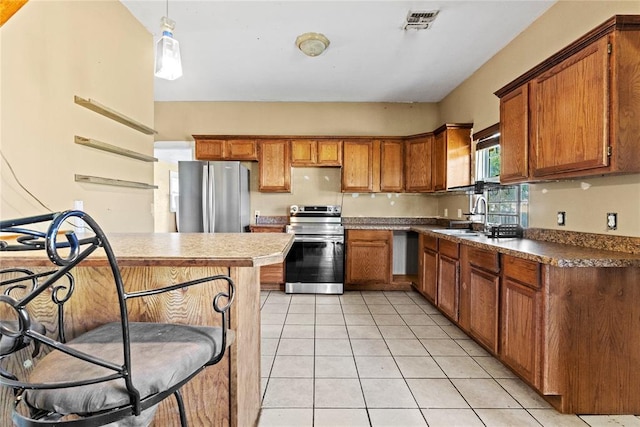 305 N Reimer, Corn, OK 73024 - kitchen featuring appliances with stainless steel finishes, a sink, brown cabinetry, light tile patterned floors, and dark countertops