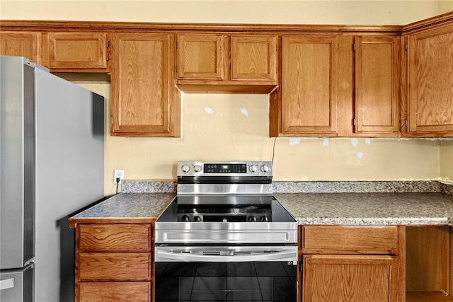 305 N Reimer, Corn, OK 73024 - kitchen with stainless steel appliances and brown cabinetry