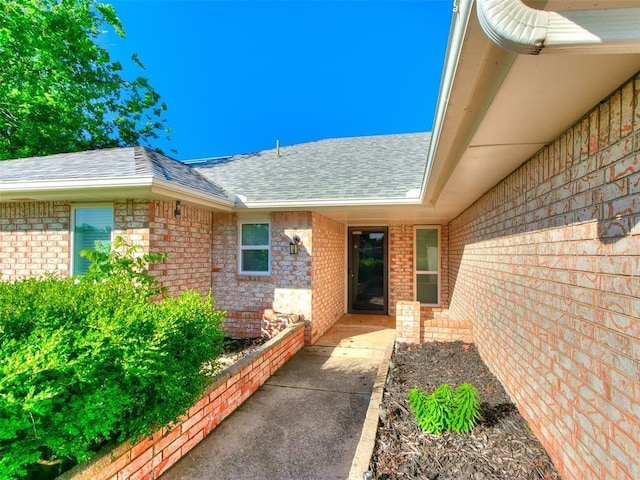 3605 Country Clb, Moore, OK 73160 - doorway to property with roof with shingles and brick siding