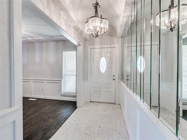 3605 Country Clb, Moore, OK 73160 - foyer entrance featuring a chandelier, a decorative wall, tile patterned floors, and a wainscoted wall