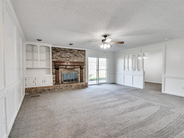 3605 Country Clb, Moore, OK 73160 - unfurnished living room with a ceiling fan, carpet floors, a fireplace, a decorative wall, and ornamental molding