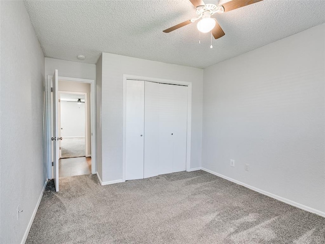 3605 Country Clb, Moore, OK 73160 - unfurnished bedroom with carpet flooring, a textured ceiling, a closet, baseboards, and a ceiling fan