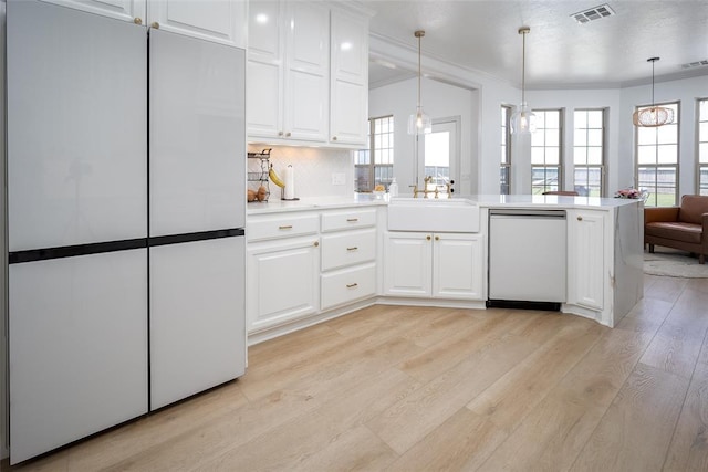 271 Taylam Rd, Goldsby, OK 73093 - kitchen featuring freestanding refrigerator, dishwashing machine, light wood-type flooring, healthy amount of natural light, and crown molding