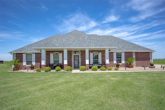 271 Taylam Rd, Goldsby, OK 73093 - view of front of property with covered porch, a shingled roof, brick siding, and a front lawn
