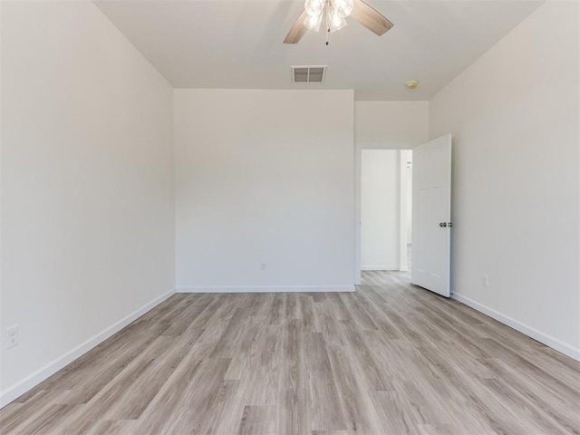 unfurnished room with light wood finished floors, a ceiling fan, and baseboards
