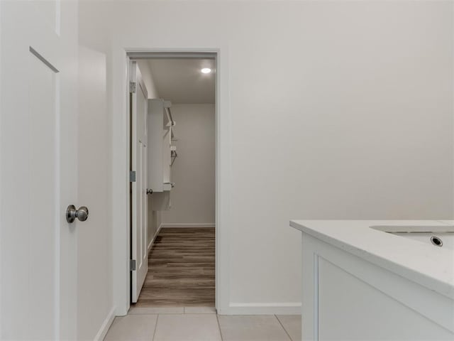 bathroom featuring tile patterned flooring, baseboards, and vanity