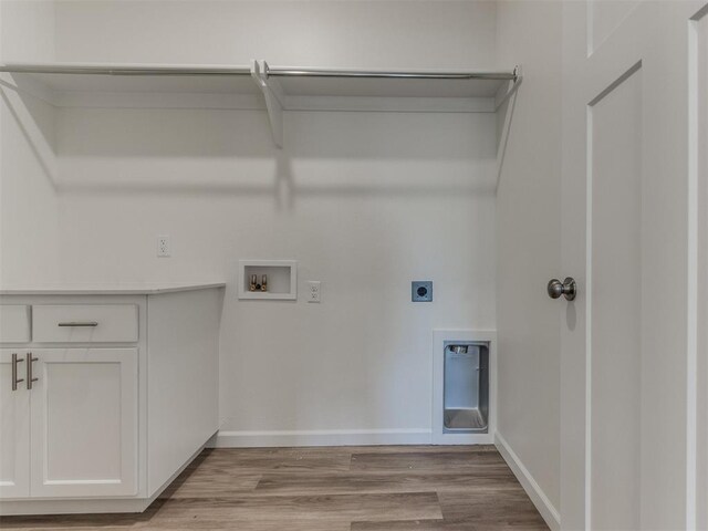 clothes washing area featuring hookup for an electric dryer, light wood-style floors, baseboards, and washer hookup
