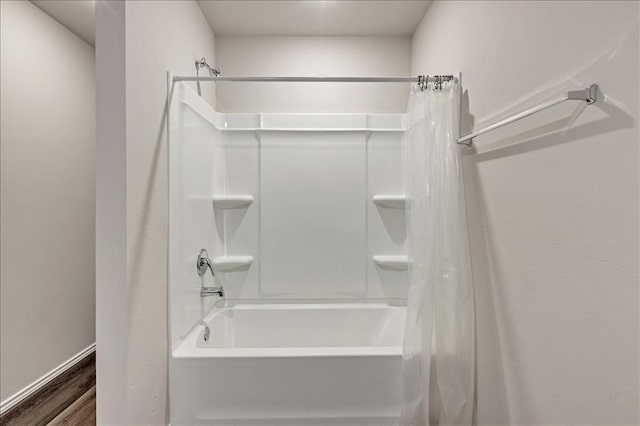 11700 NW 95th St, Yukon, OK 73099 - bathroom featuring shower / bath combination with curtain and wood finished floors