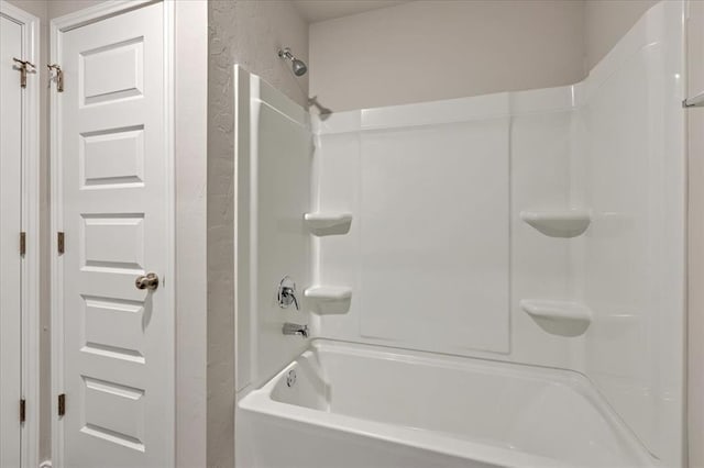 11700 NW 95th St, Yukon, OK 73099 - bathroom featuring a textured wall and washtub / shower combination