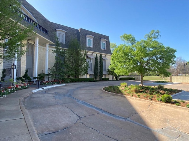 1114 Sherwood Ln Unit B-2, Nichols Hills, OK 73116 - view of asphalt road with curbs and sidewalks