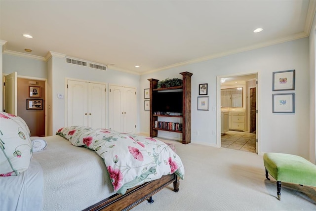 1114 Sherwood Ln Unit B-2, Nichols Hills, OK 73116 - bedroom with two closets, recessed lighting, ornamental molding, light carpet, and connected bathroom