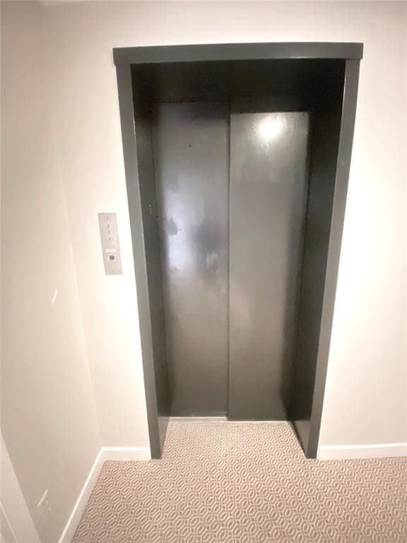 1114 Sherwood Ln Unit B-2, Nichols Hills, OK 73116 - detailed view of elevator, baseboards, and carpet floors
