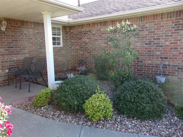 1926 E Aspen Pl, Shawnee, OK 74804 - view of exterior entry featuring roof with shingles and brick siding