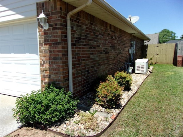1926 E Aspen Pl, Shawnee, OK 74804 - view of side of property with brick siding and a garage
