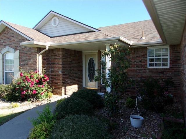 1926 E Aspen Pl, Shawnee, OK 74804 - doorway to property with a shingled roof and brick siding