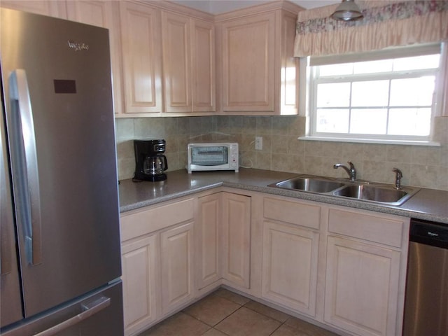 1926 E Aspen Pl, Shawnee, OK 74804 - kitchen featuring appliances with stainless steel finishes, a sink, tasteful backsplash, and light tile patterned floors