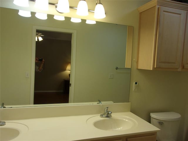1926 E Aspen Pl, Shawnee, OK 74804 - bathroom with double vanity, toilet, and ceiling fan