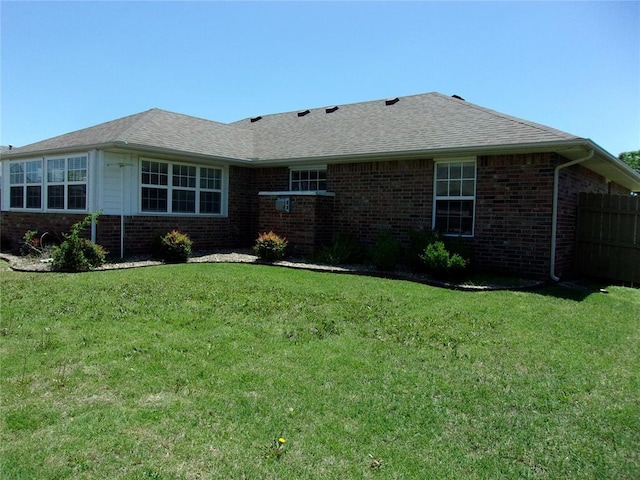 1926 E Aspen Pl, Shawnee, OK 74804 - rear view of property with brick siding, a yard, and roof with shingles
