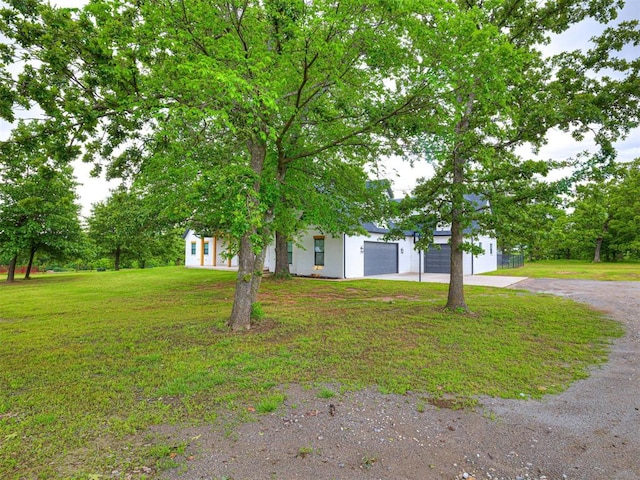 1614 S 1st Ave, Stroud, OK 74079 - view of front of home with driveway, a front lawn, and an attached garage
