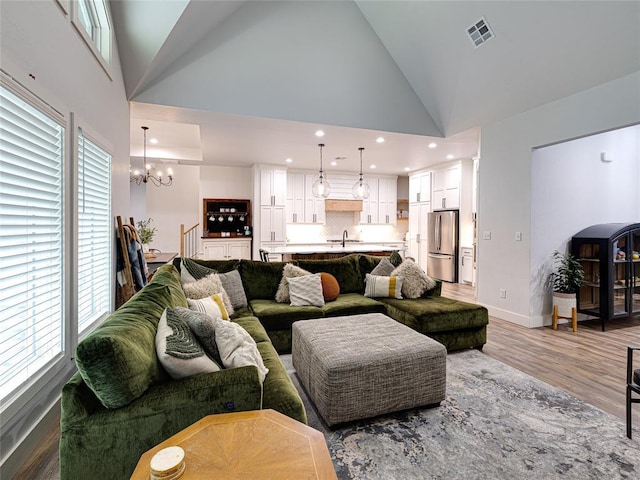1614 S 1st Ave, Stroud, OK 74079 - living area with a chandelier, wood finished floors, recessed lighting, baseboards, and high vaulted ceiling