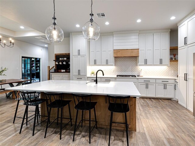 1614 S 1st Ave, Stroud, OK 74079 - kitchen featuring stainless steel gas stovetop, a sink, backsplash, light wood finished floors, and recessed lighting