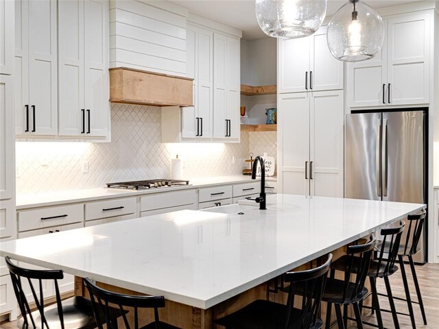 1614 S 1st Ave, Stroud, OK 74079 - kitchen with a sink, appliances with stainless steel finishes, open shelves, backsplash, and light countertops
