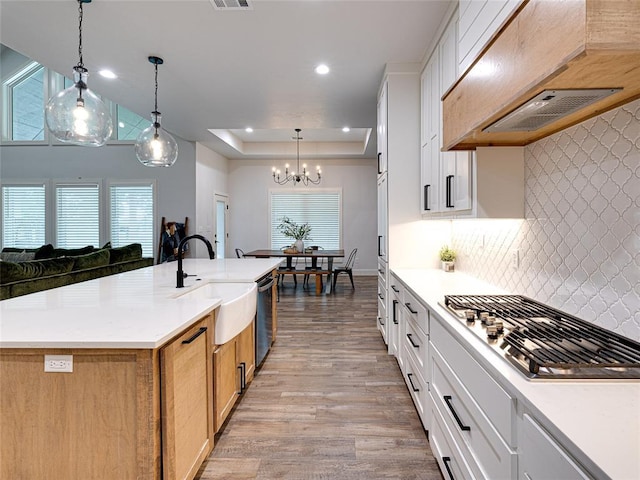1614 S 1st Ave, Stroud, OK 74079 - kitchen featuring a sink, extractor fan, stainless steel gas stovetop, dishwasher, and a chandelier