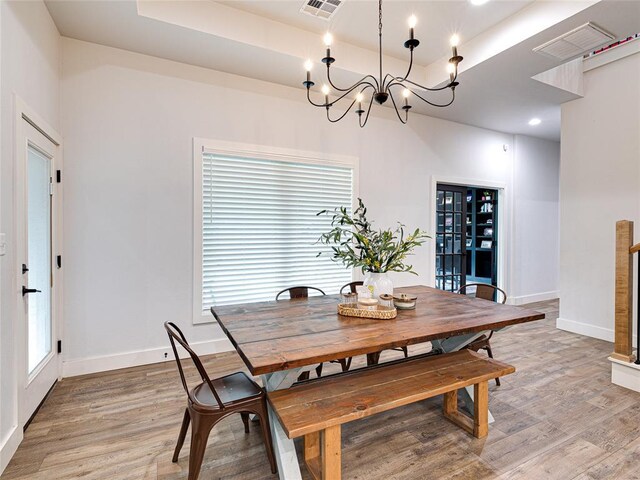 1614 S 1st Ave, Stroud, OK 74079 - dining area with baseboards, a chandelier, and light wood-type flooring