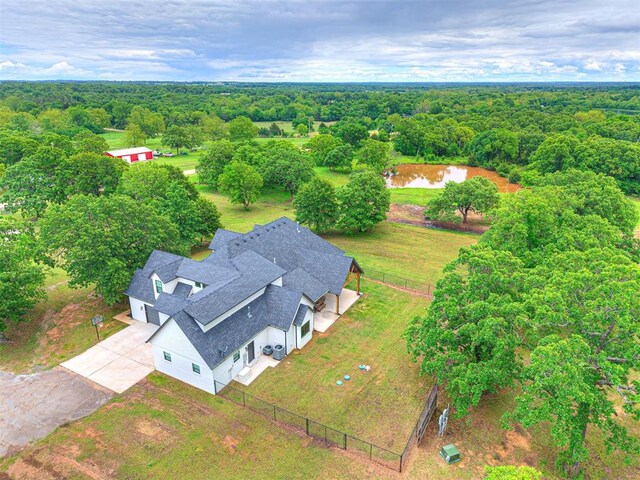 1614 S 1st Ave, Stroud, OK 74079 - aerial view of property and surrounding area with a heavily wooded area and a nearby body of water