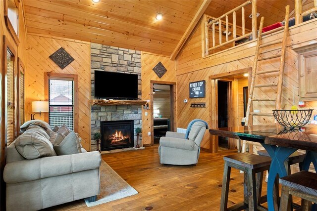 962 Red Fox Rd, Broken Bow, OK 74728 - living area featuring wood walls, wood ceiling, hardwood / wood-style flooring, a fireplace, and high vaulted ceiling