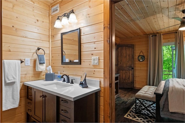 962 Red Fox Rd, Broken Bow, OK 74728 - bathroom with wood walls, wooden ceiling, hardwood / wood-style floors, and vanity