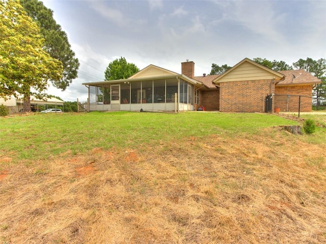 13776 E Stella Rd, Newalla, OK 74857 - rear view of property with a sunroom, a chimney, and brick siding