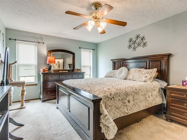 13776 E Stella Rd, Newalla, OK 74857 - bedroom with light carpet, a textured ceiling, multiple windows, and ceiling fan