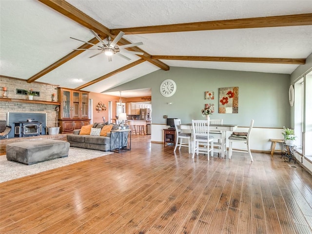 13776 E Stella Rd, Newalla, OK 74857 - living room featuring plenty of natural light, wood finished floors, a ceiling fan, a wood stove, and a textured ceiling