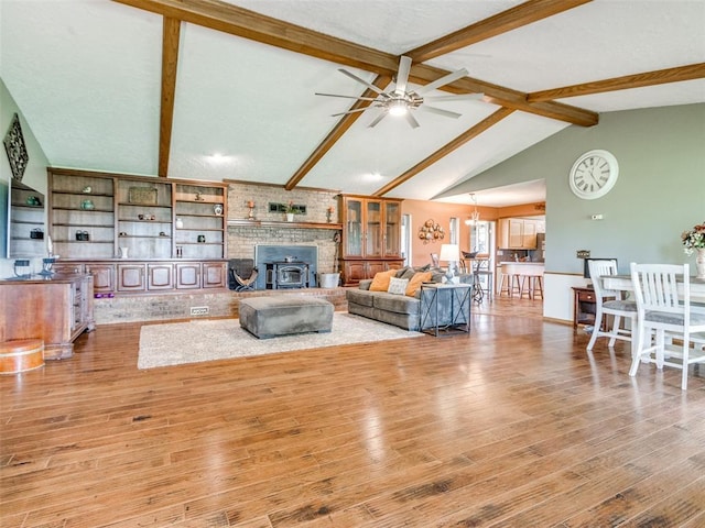 13776 E Stella Rd, Newalla, OK 74857 - living room featuring a ceiling fan, wood finished floors, and a wood stove