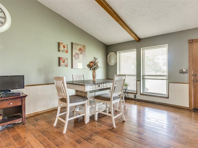 13776 E Stella Rd, Newalla, OK 74857 - dining area featuring a textured ceiling, wood finished floors, and a wainscoted wall