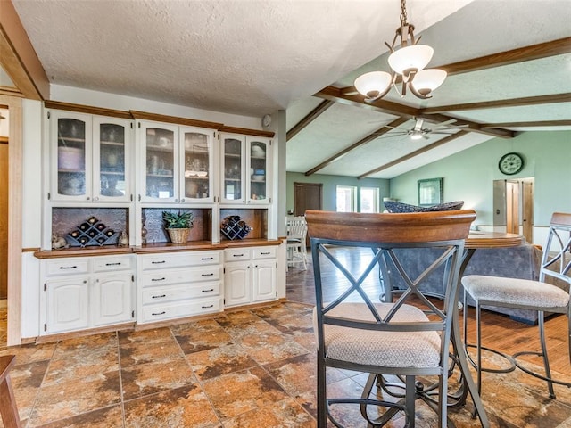13776 E Stella Rd, Newalla, OK 74857 - kitchen featuring a ceiling fan, glass insert cabinets, white cabinets, a chandelier, and a textured ceiling