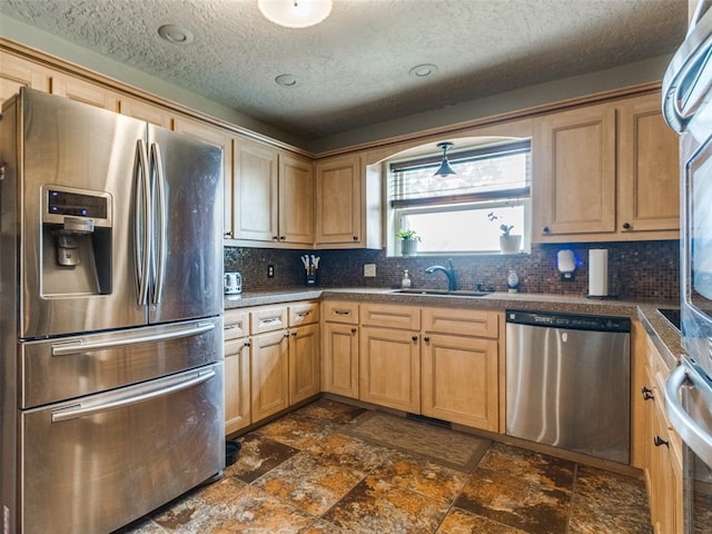 13776 E Stella Rd, Newalla, OK 74857 - kitchen with stainless steel appliances, a sink, backsplash, dark stone finish floors, and a textured ceiling