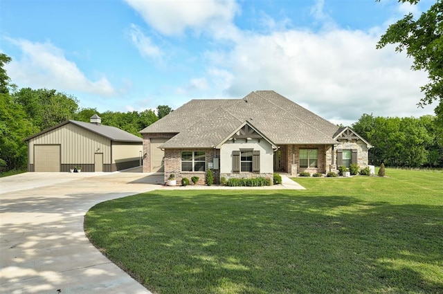 12535 Memory Ln, Edmond, OK 73025 - view of front of home featuring stone siding, a detached garage, an outbuilding, a front lawn, and roof with shingles