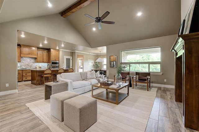 12535 Memory Ln, Edmond, OK 73025 - living area with beam ceiling, ceiling fan, high vaulted ceiling, baseboards, and light wood-style floors
