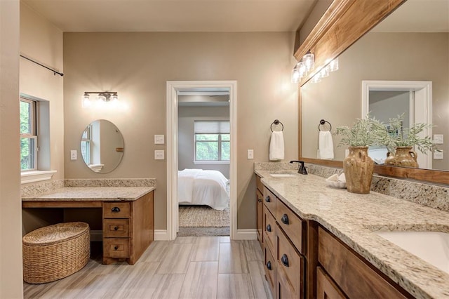 12535 Memory Ln, Edmond, OK 73025 - bathroom featuring double vanity, ensuite bathroom, and baseboards