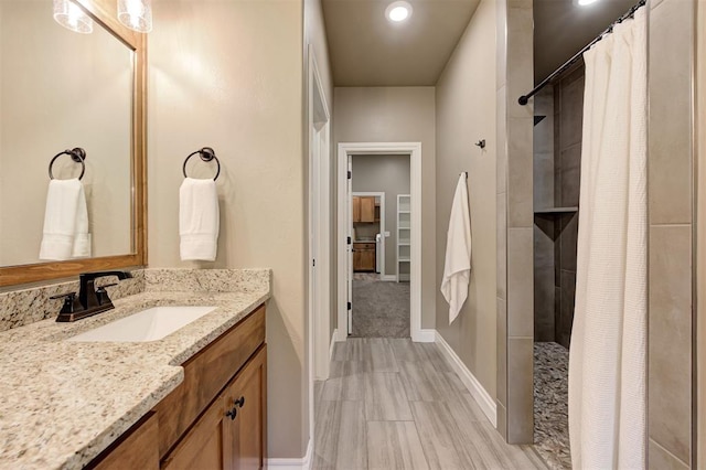 12535 Memory Ln, Edmond, OK 73025 - bathroom with a shower with curtain, vanity, baseboards, and recessed lighting