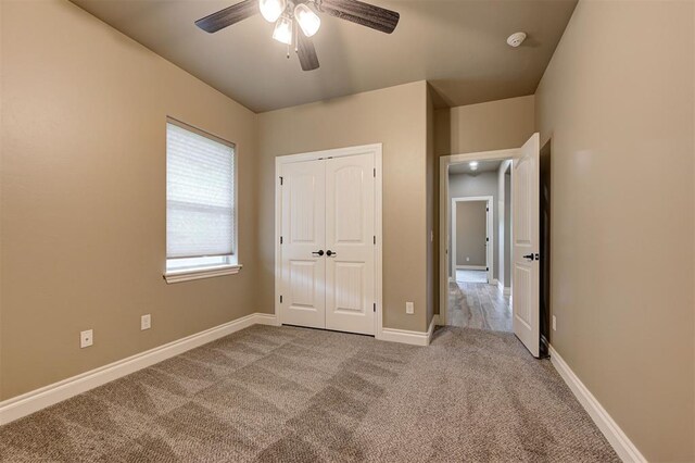 12535 Memory Ln, Edmond, OK 73025 - unfurnished bedroom with carpet, a closet, baseboards, and ceiling fan