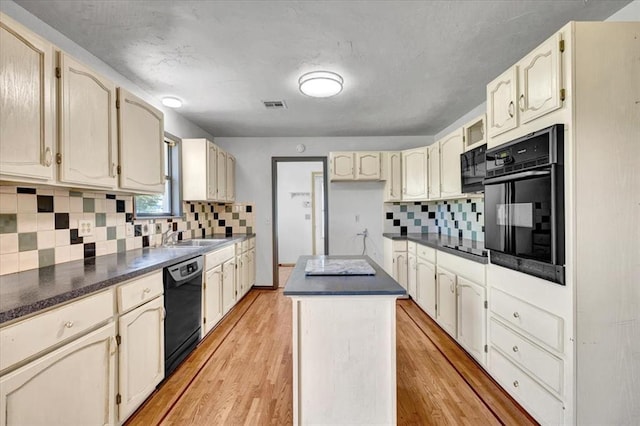 15001 Garr Pl, Oklahoma City, OK 73165 - kitchen with black appliances, dark countertops, tasteful backsplash, and a center island